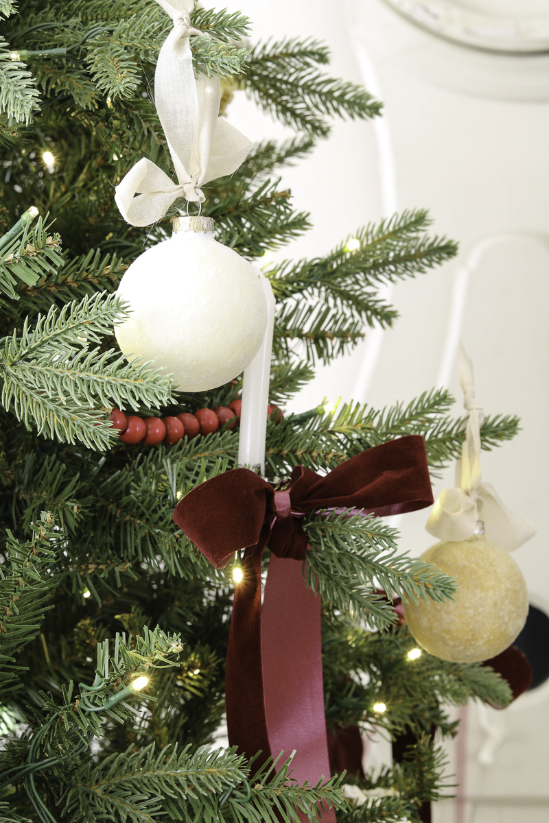Decorating a Christmas tree with velvet ornaments