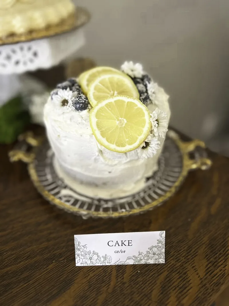 Mini cake for enchanted garden bridal shower decorated with lemons, blueberries and chamomile