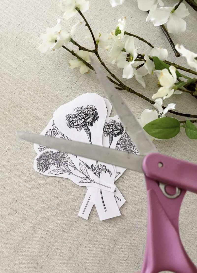Cutting out birth month flower for a glass cylinder candle holder for a DIY project
