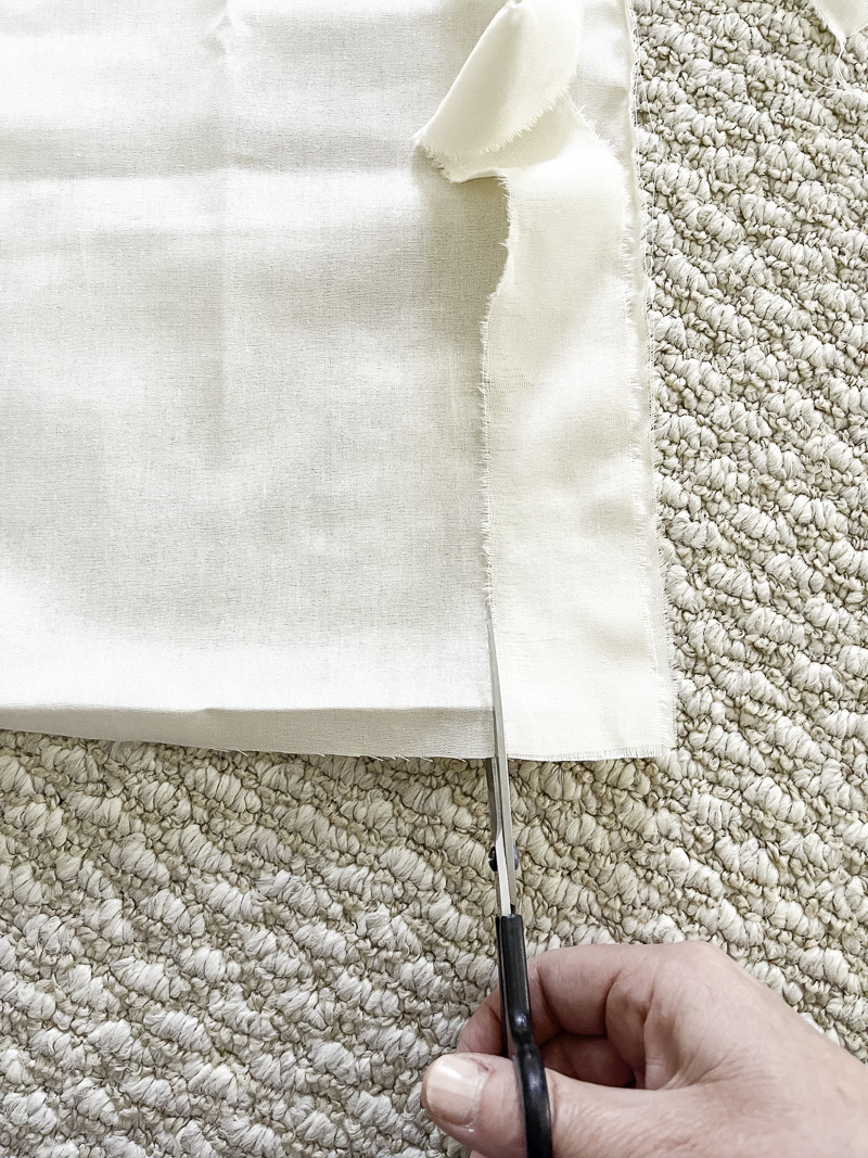Step one of how to make ribbon from fabric.  Using a ribbon as a guide cut into the fabric