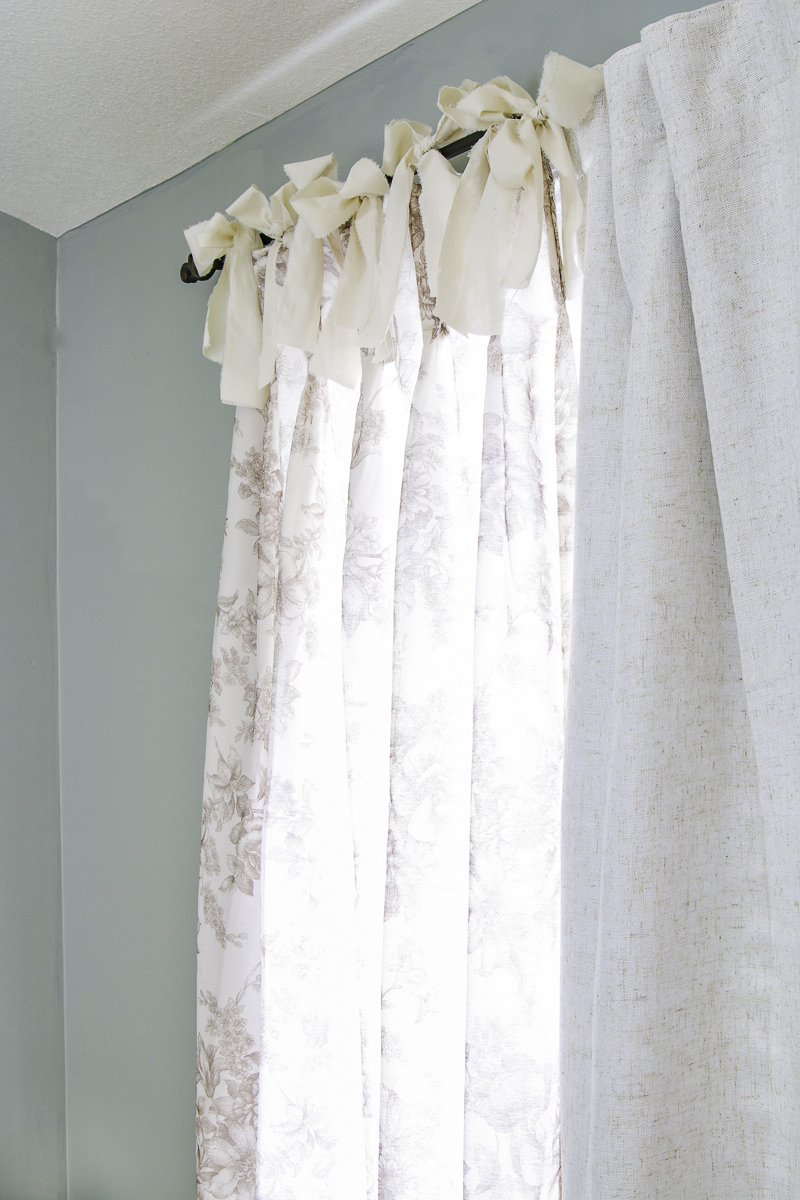 Handmade fabric ribbon bows on top of a curtain