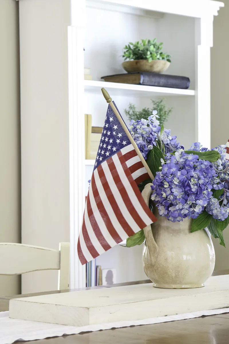 Patriotic centerpiece using hydrangeas, American flags in an ironstone pitcher