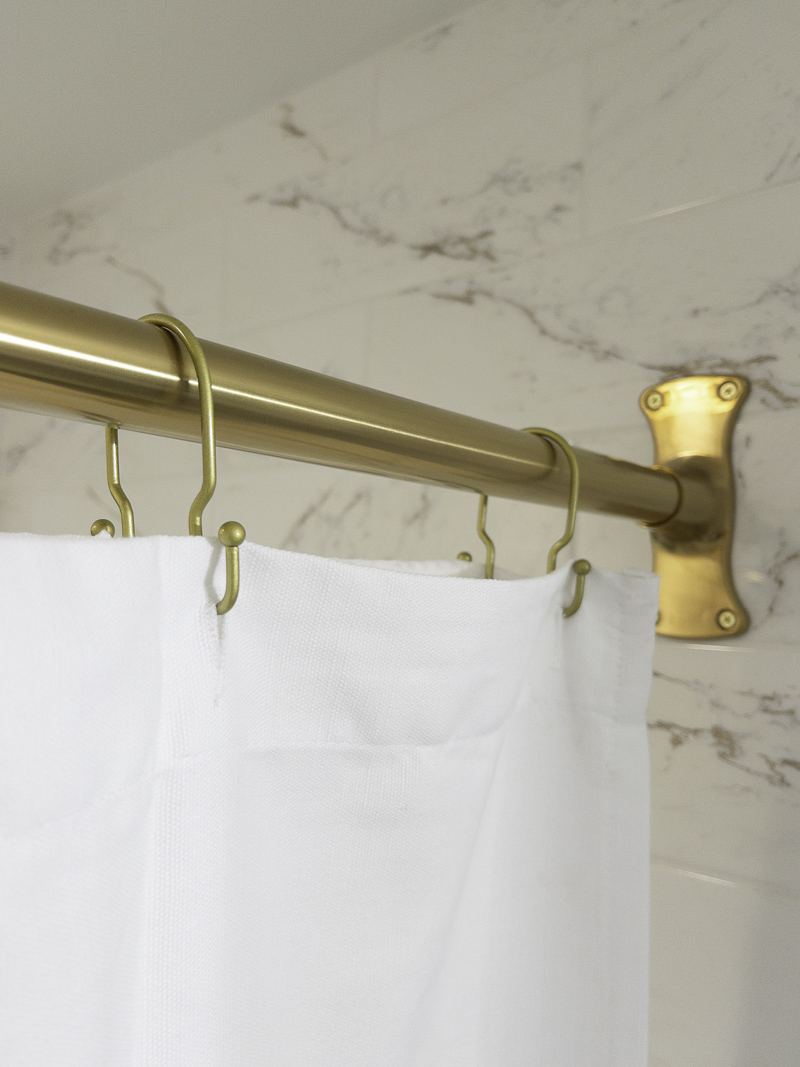 Shower curtain rod in a guest bathroom design