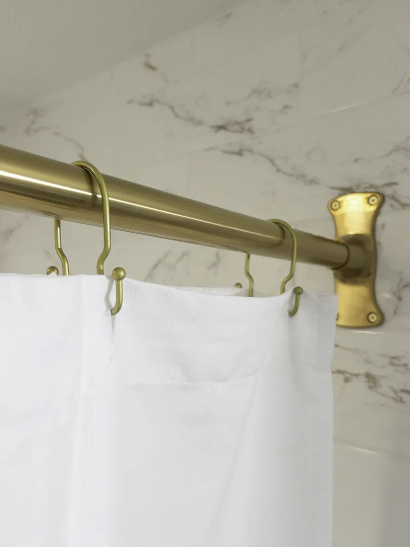 Shower curtain rod in a guest bathroom design