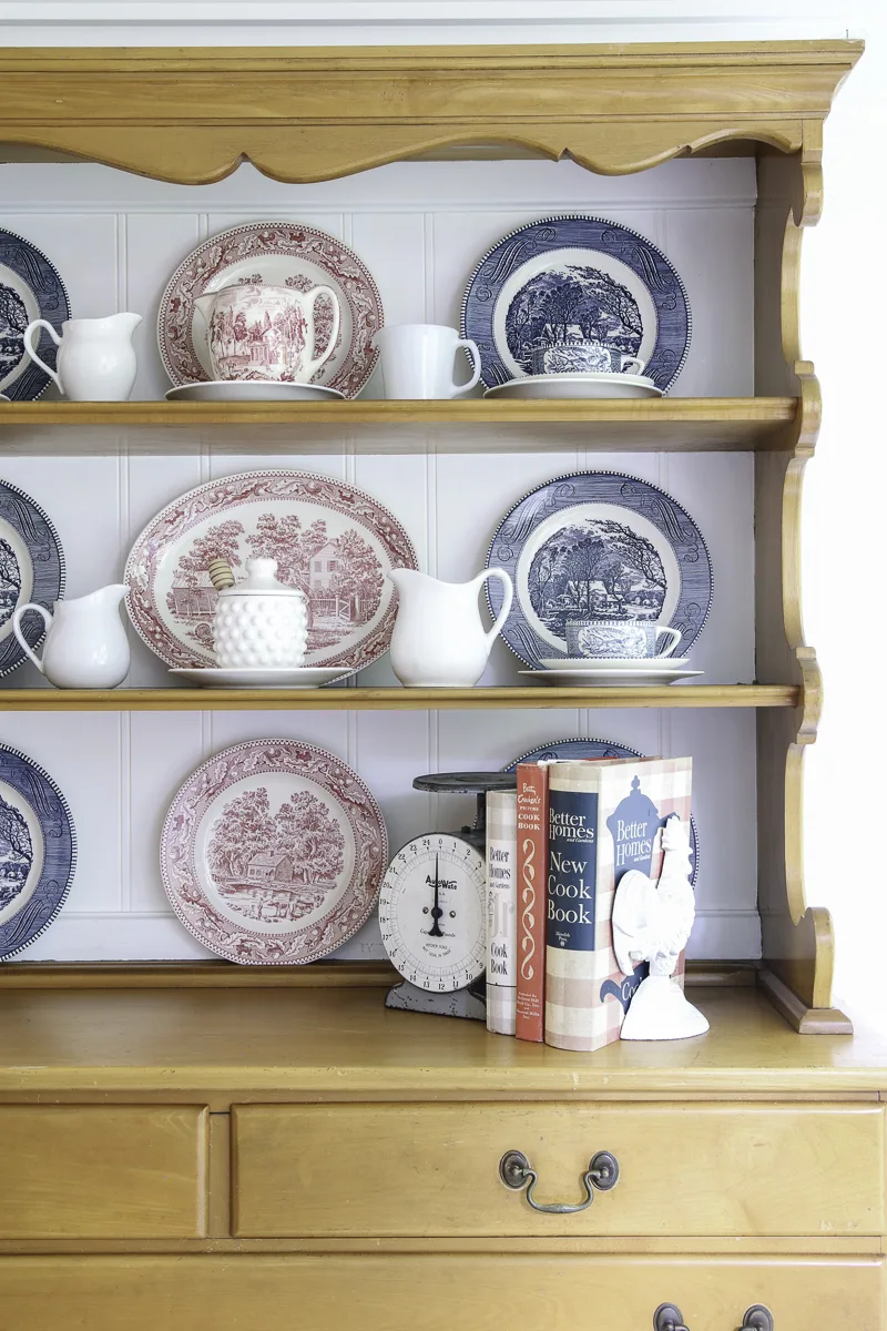 Blue Currier and Ives dishes, red transferware dishes and white create a patriotic design for the hutch