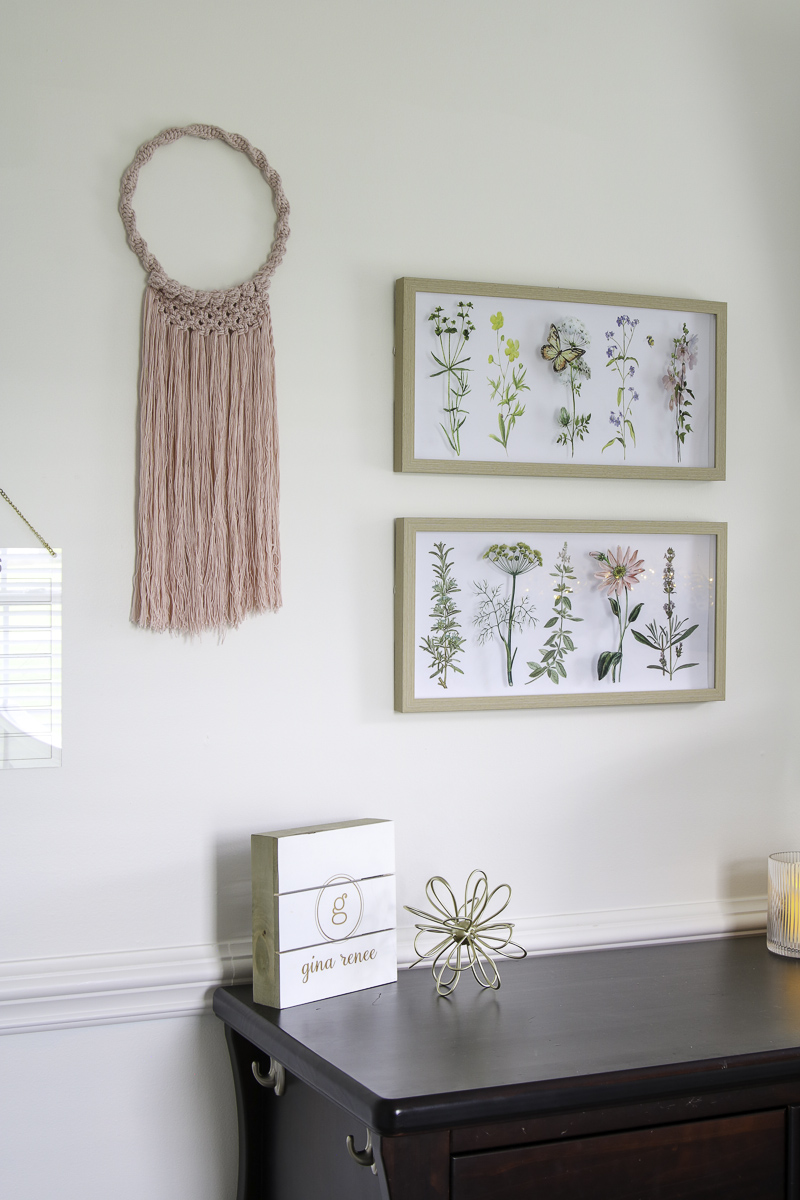 Preteen boho minimalist bedroom gallery wall with wildflower and butterfly art and pink macrame