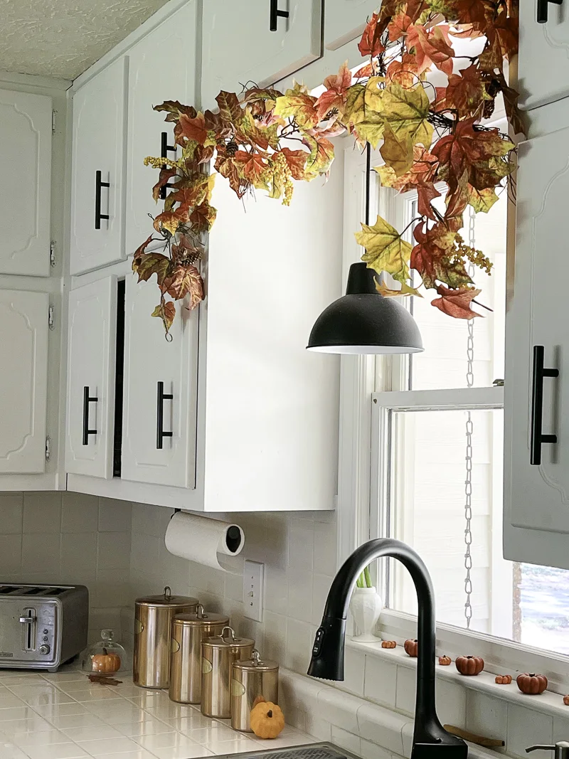 Autumn leaf garland over a sink in a kitchen