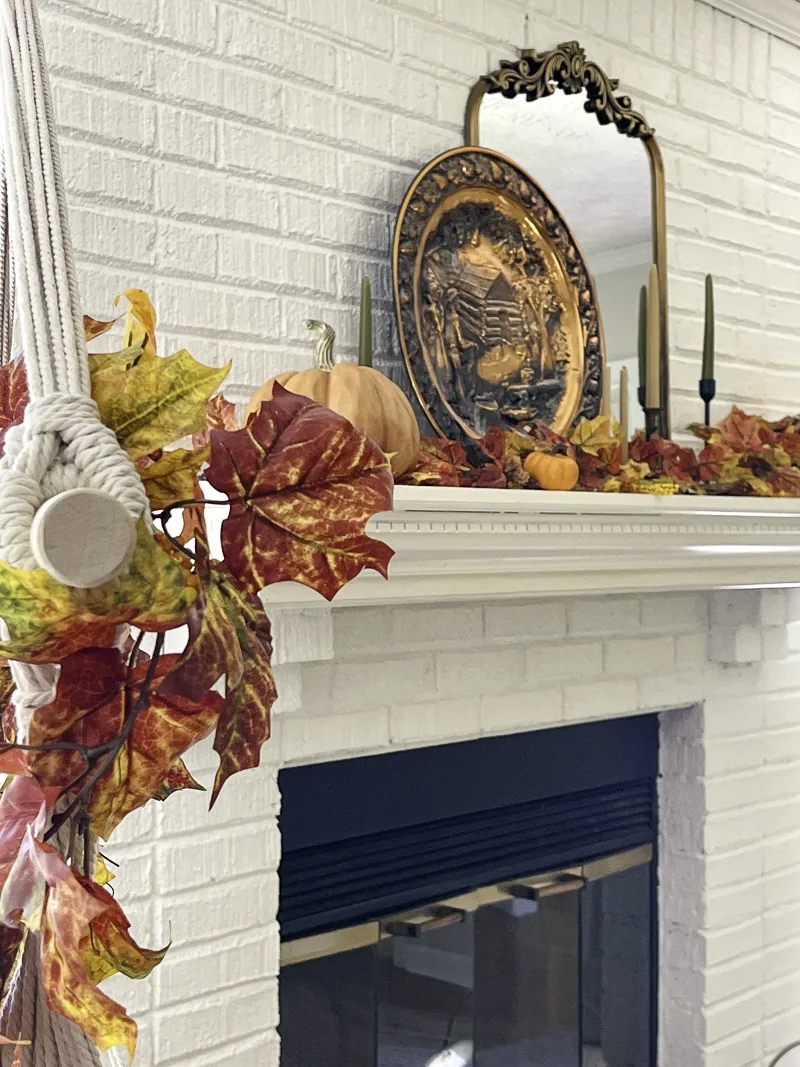 Decorating the mantel with orange and copper for fall