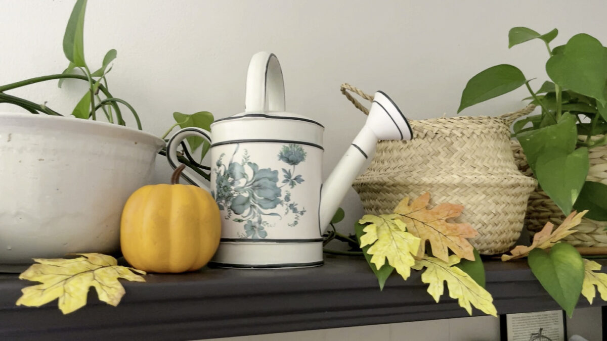 Decorated hutch with orange pumpkins and leaves