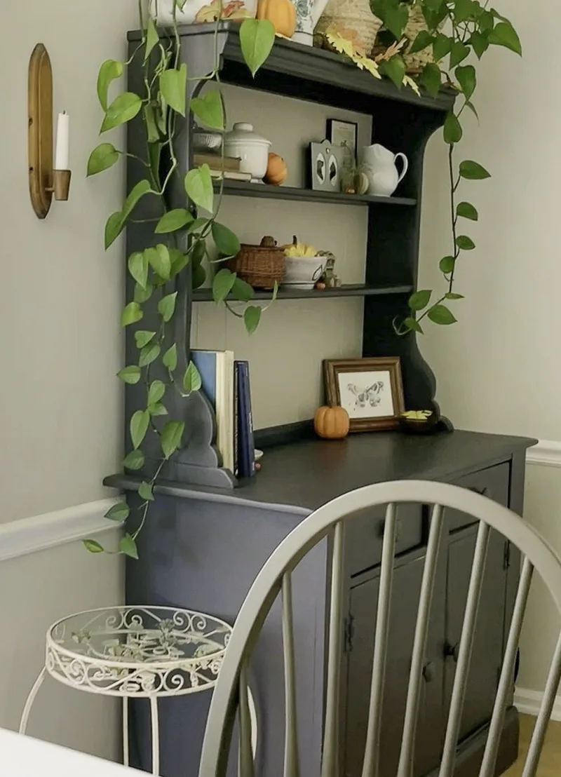 Decorated hutch with orange pumpkins and leaves