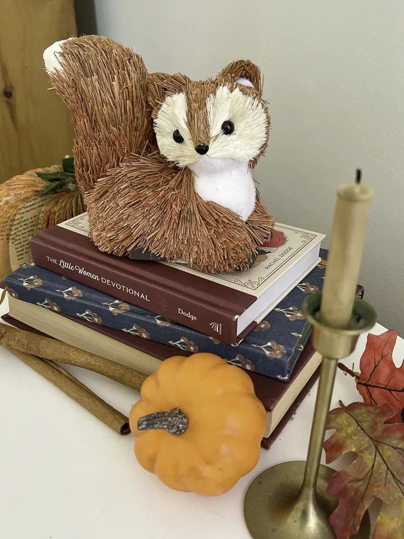 Cute squirrel decorations for autumn and a mini pumpkin and brass candle