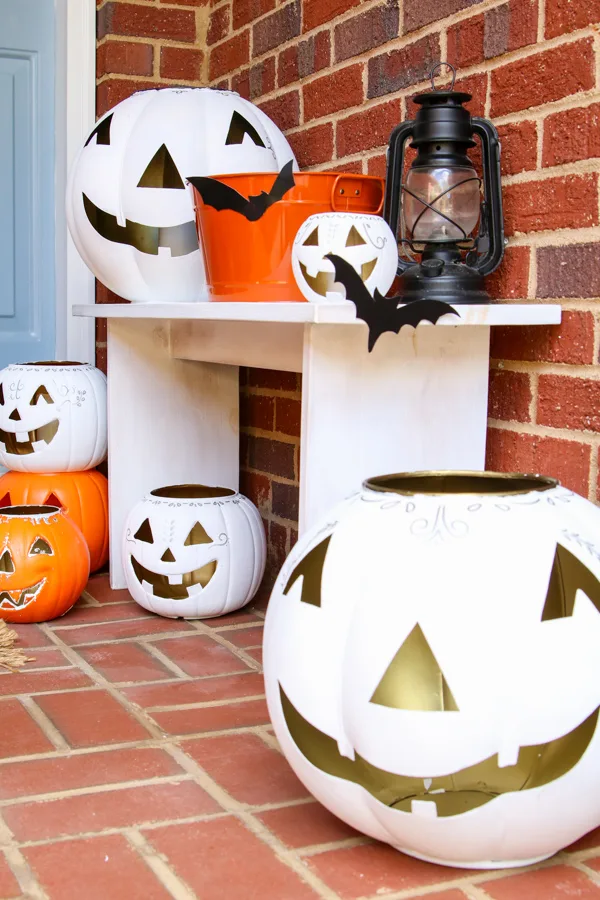 Retro front porch decor ideas using white and orange jack o lanterns and silhouettes