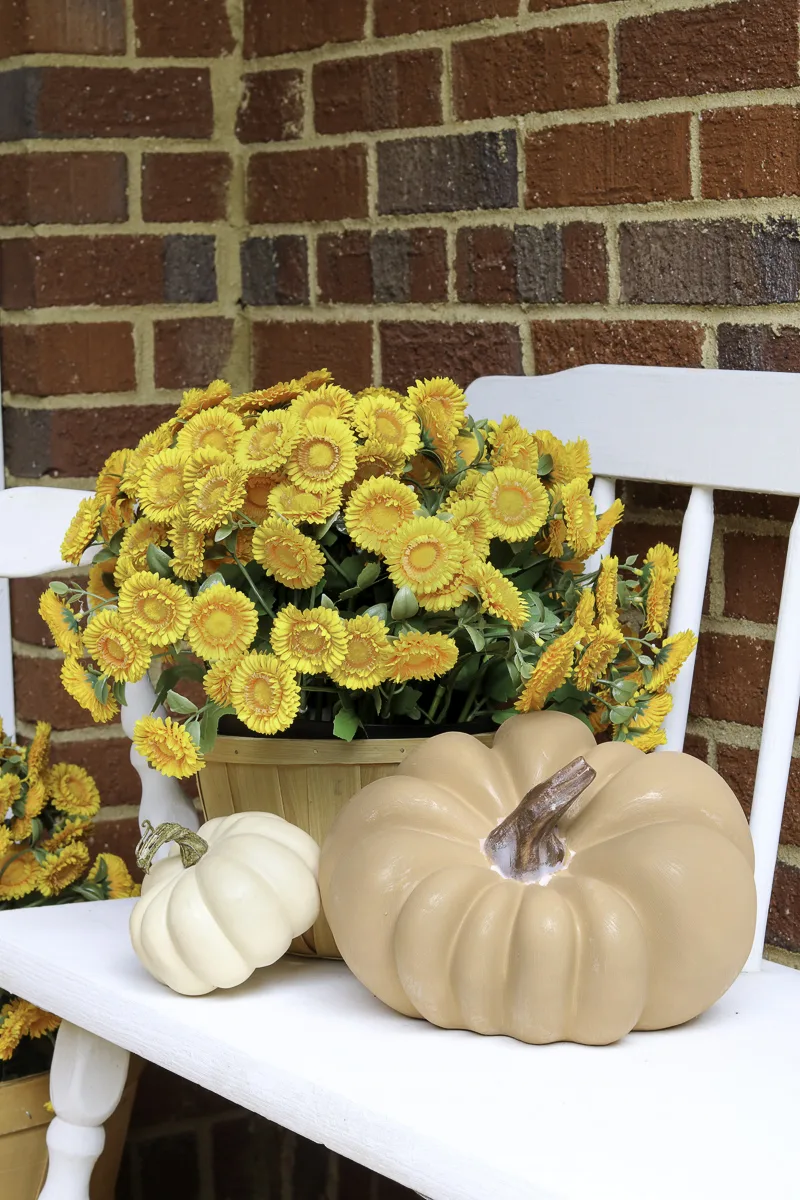 Front porch pumpkin decor ideas using faux pumpkins on a bench