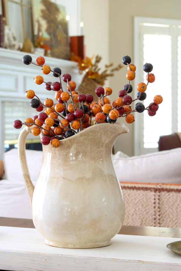 Ironstone pitcher with autumn berries as a centerpiece for our table decorating in neutral and orange fall colors