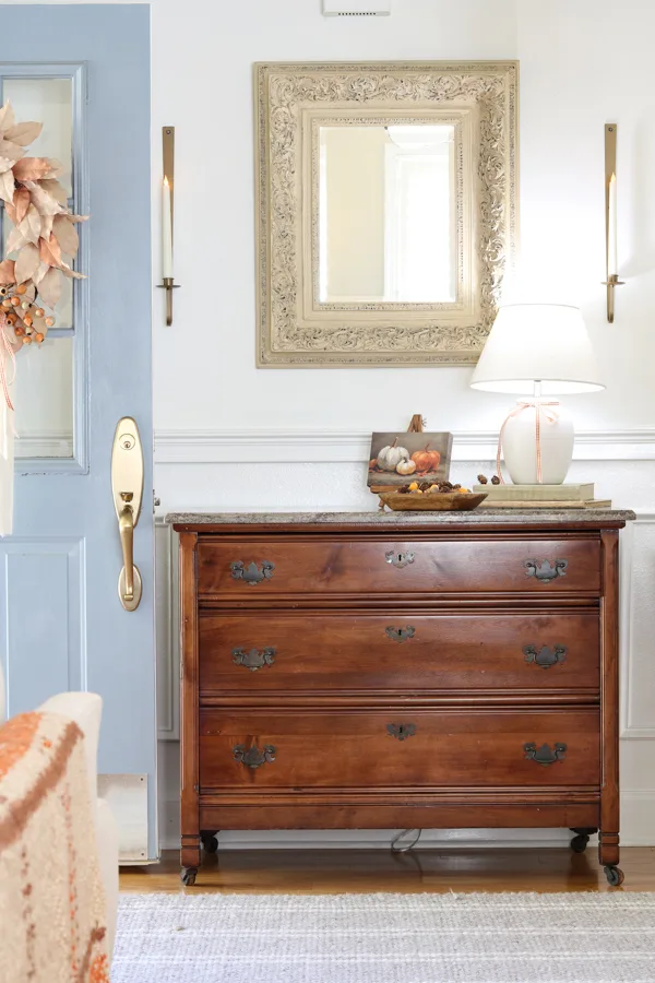 Neutral and orange fall decorations in the entryway