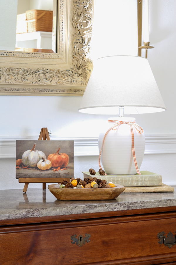 Neutral and orange fall decorations in the entryway