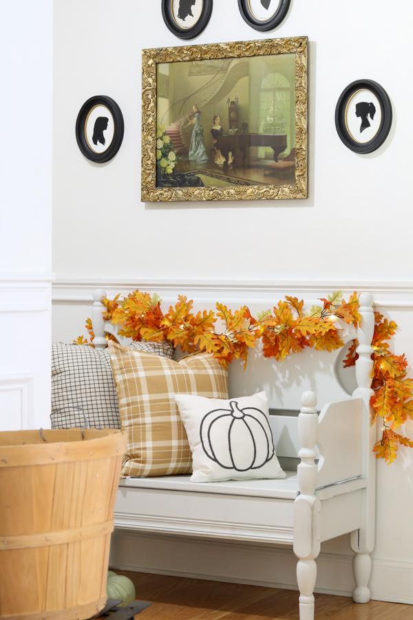 Neutral and orange fall decorations in the entryway