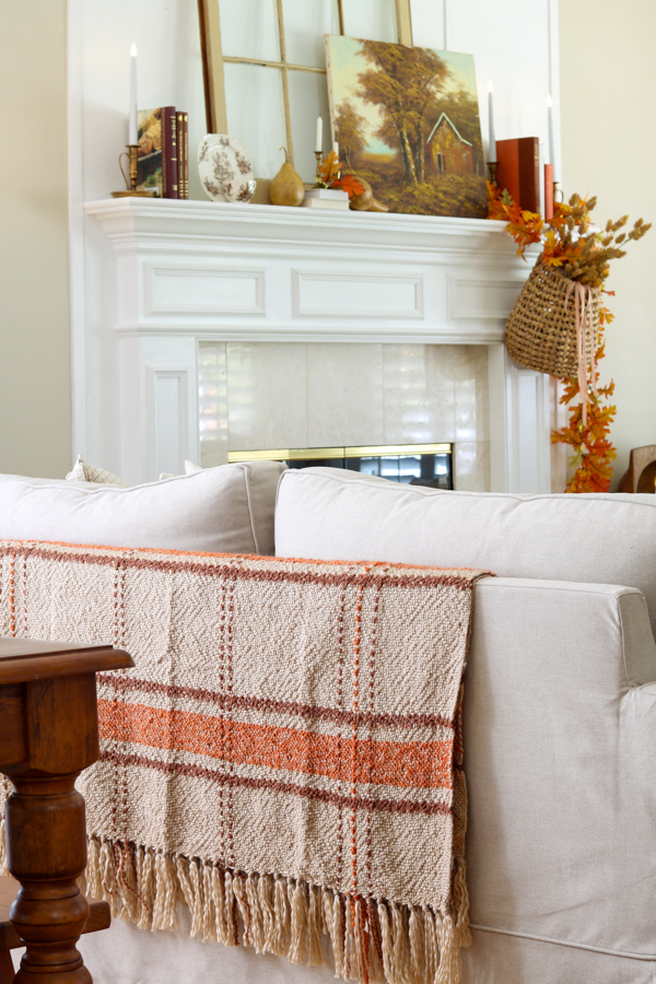 neutral and orange fall decor ideas on the fireplace mantel