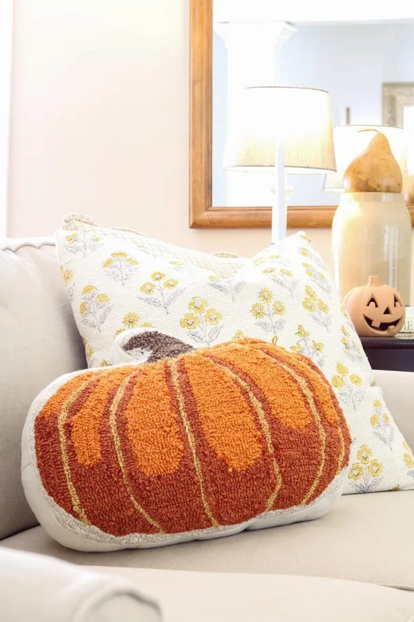 Fall needlepoint pillow used to decorate in neutral and orange fall colors