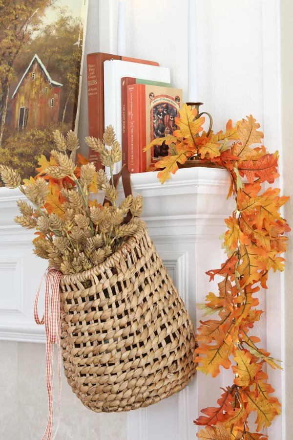 neutral and orange fall decor ideas on the fireplace mantel