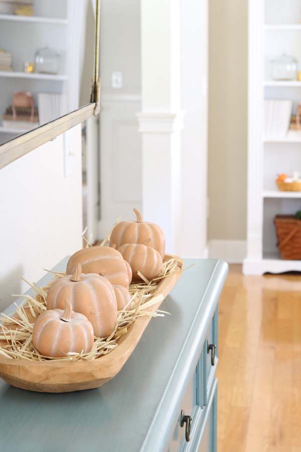 neutral and orange fall decor ideas featuring terracotta pumpkins