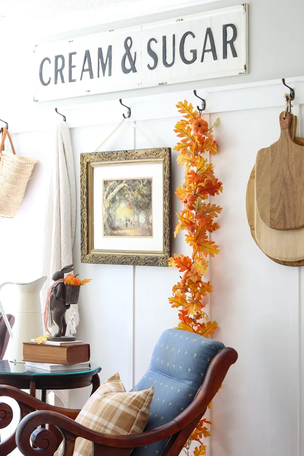 Neutral and orange fall decorations in the kitchen sitting area