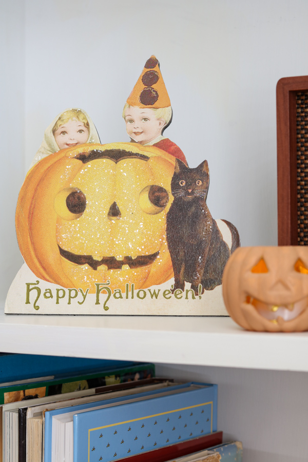 Decorating a bookcase with jack o lanterns