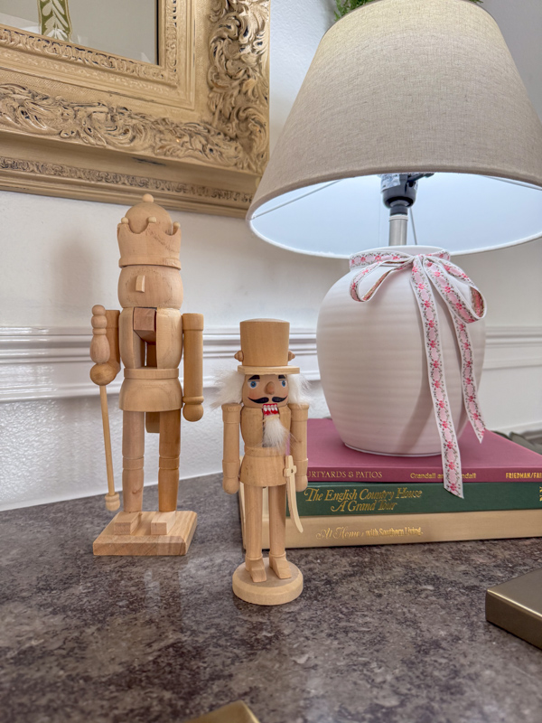 nutcrackers on table and lamp with christmas ribbon