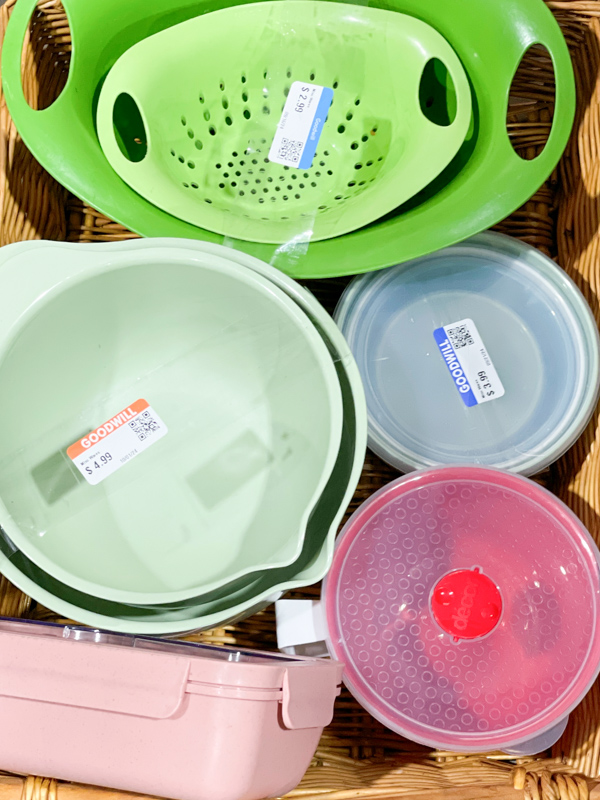 A basket of plastic bowls and such at Goodwill