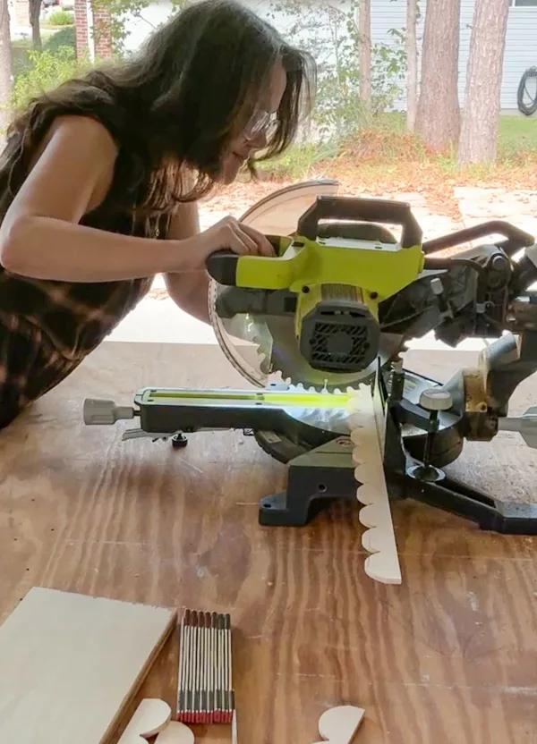 Sawing trim to make a DIY Scalloped Wood Tray