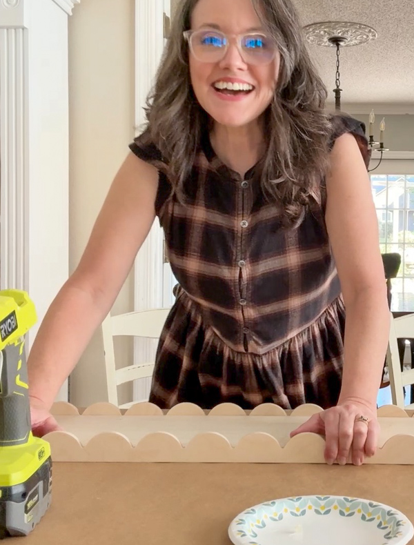 Gluing trim to a base to make a DIY Scalloped Wood Tray