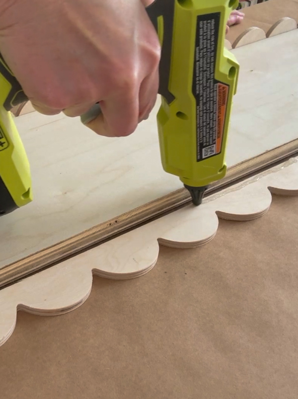 Adding hot glue to trim to make aDIY Scalloped Wood Tray