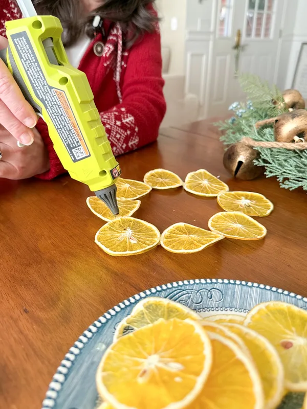 hot glue the slices together in a wreath shape