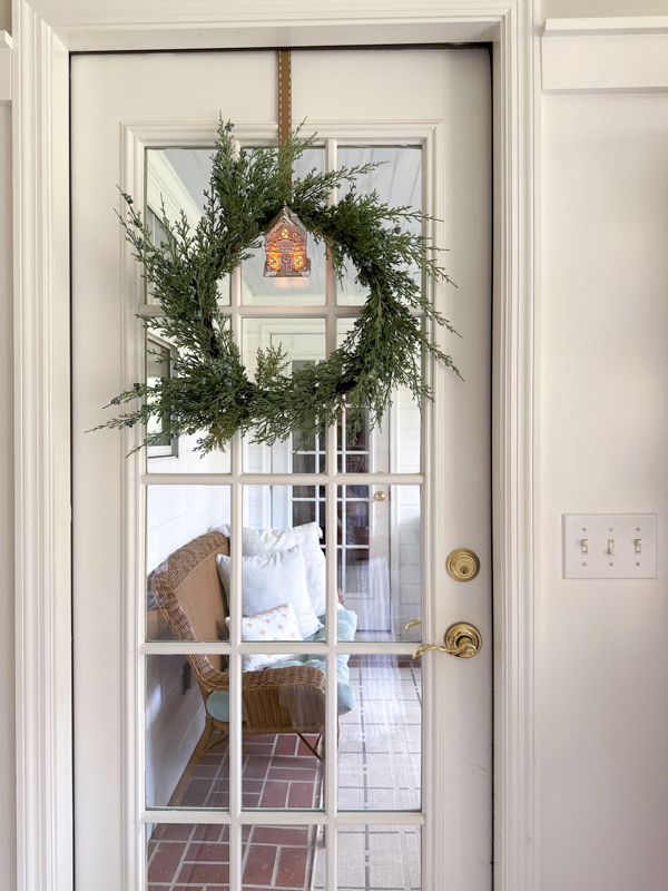 diy gingerbread house wreath hanger hanging from door