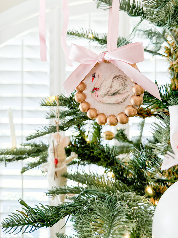 Decorating a Christmas tree with homemade frame ornament