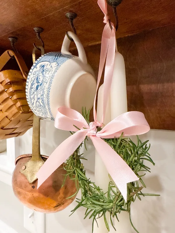 hanging rosemary wreath with pink bow