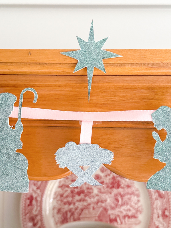 close up of jesus, mary, joseph and star on hanging garland