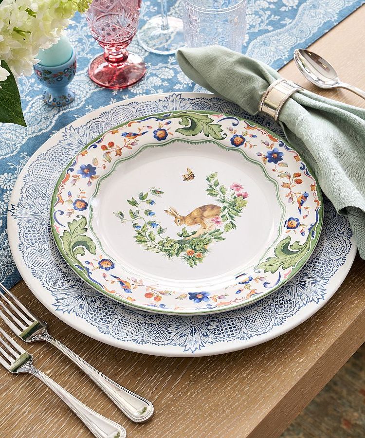 Pottery Barn spring collection of botanical bunny place setting.  This is a floral design with a brown bunny rabbit in the middle.  Lace design of blue and white the chargers.  Such a beautiful representation of springtime.