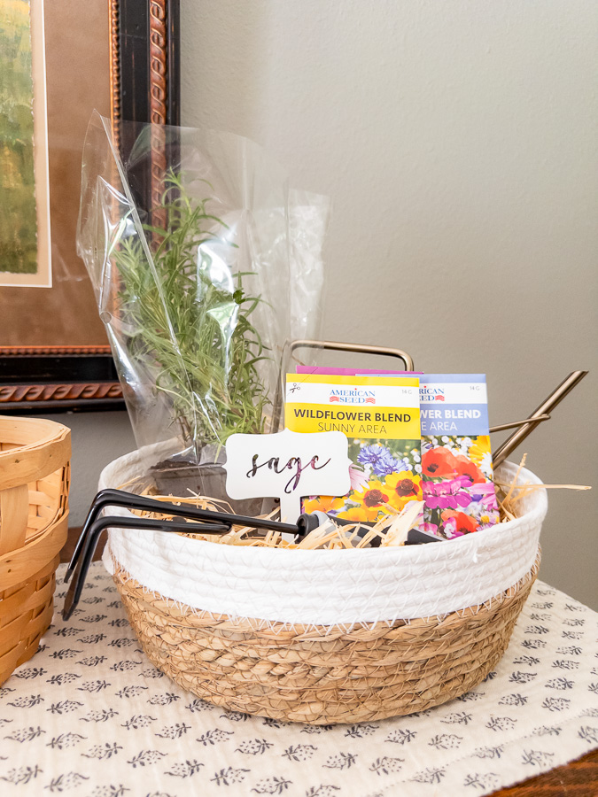 Gardening housewarming basket with watering can, herb plant, and flower seeds