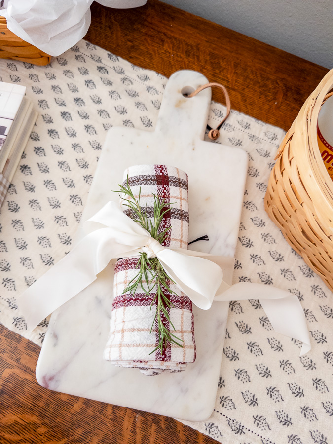 Marble cutting board and Hearth & Hand kitchen towel tied with ribbon for a new homeowner