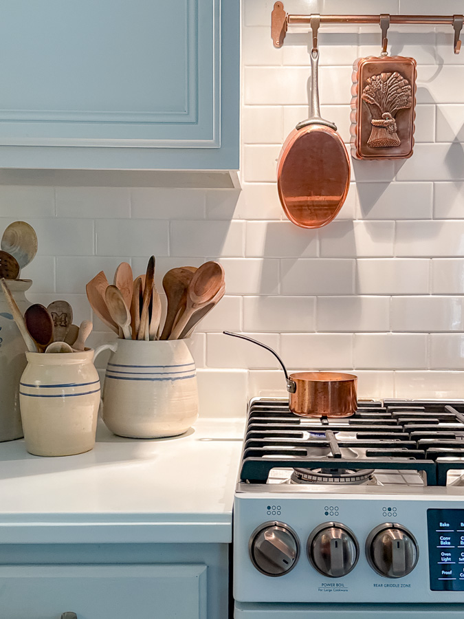 Small copper pot sitting on a stove used to make a pumpkin spice simmer pot for autumn