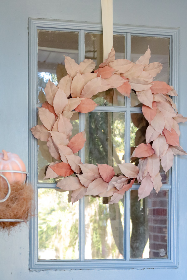 Netural leaf garland fall wreath decoration on a blue door