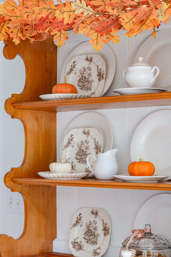 tiny pumpkins on kitchen hutch