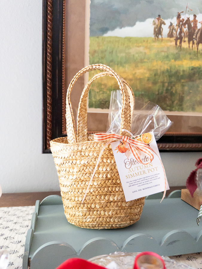 Mini market basket filled with simmer pot ingredients tied with ribbon and gift tag