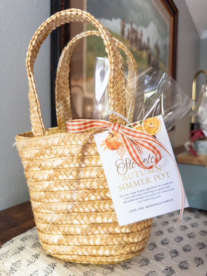 Mini market basket filled with simmer pot ingredients tied with ribbon and gift tag
