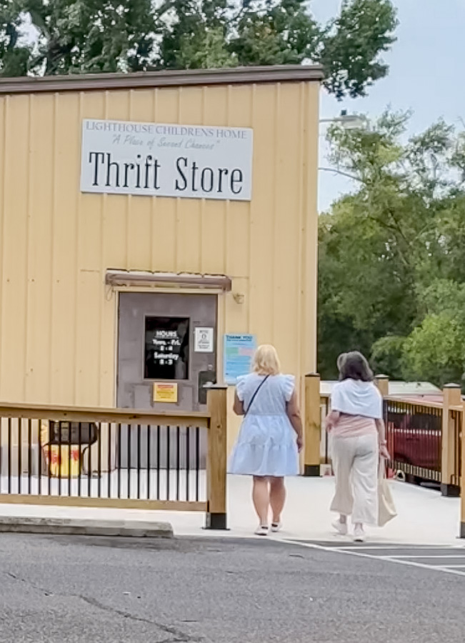 Two women walkign to a thrift store