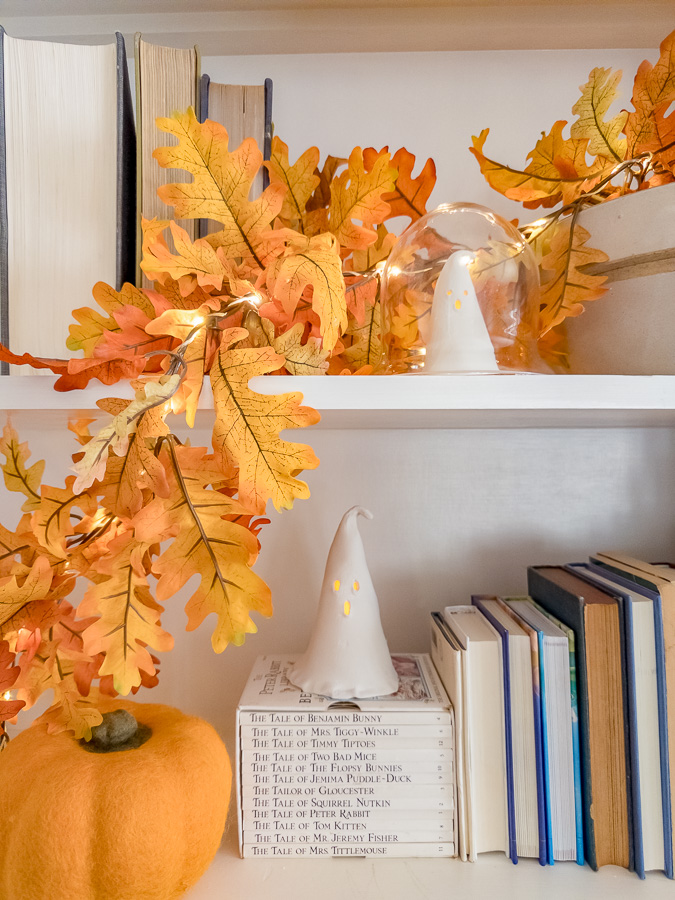 DIY ghost cloche with small glowing ghost under glass dome.