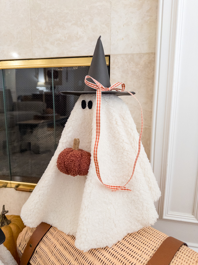 Sherpa ghost diy sitting on a basket and pumpkins