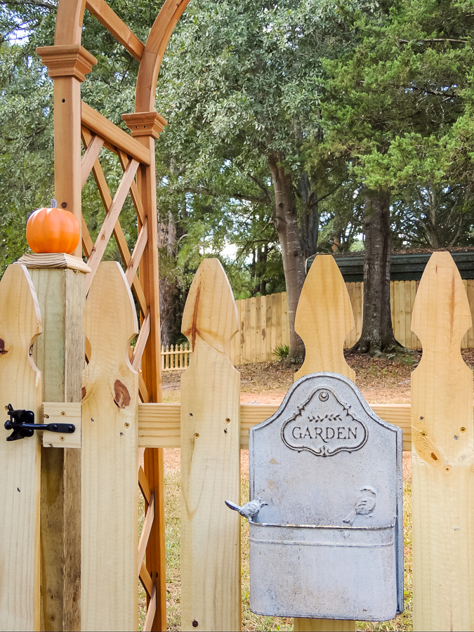 English cottage picket frence gate with wall planter.