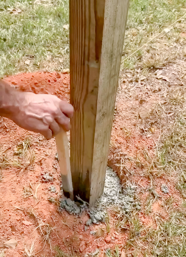 Adding 4 x 4 posts in holes with cement.
